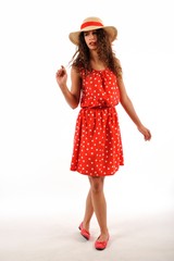 The girl in red polka dot dress with hat