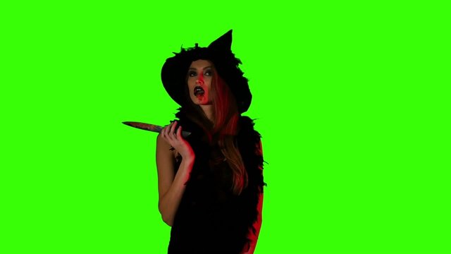 Halloween witch with a knife  on green screen