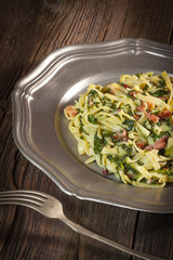 Spaghetti with spinach and bacon.