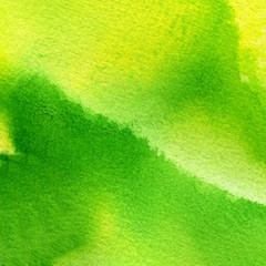 Abstract hand painted watercolor background of warm green and yellow colors 