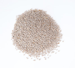 Closeup of pile of chia seeds against white