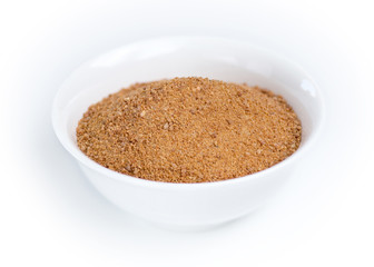 Coconut sugar in a white bowl against white