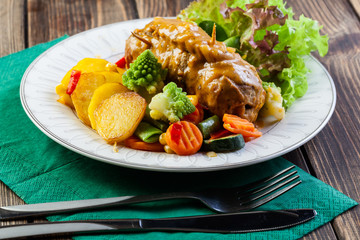 Pork rolls with prepared potatoes and vegetables