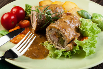 Pork rolls with prepared potatoes and vegetables