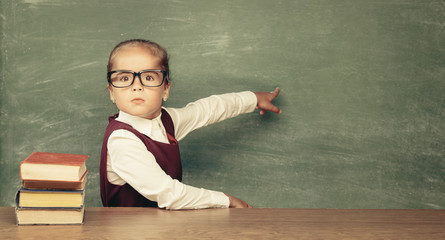 Girl (child) against chalkboard