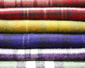 pure Scottish wool scarves stacked ready to be sold, many colors and an extraordinary softness