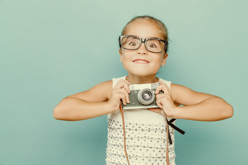 child holding a instant camera