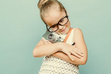 child holding a instant camera