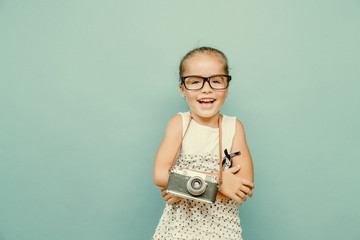 child holding a instant camera