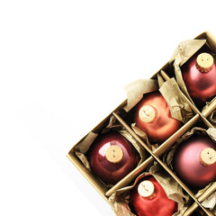 Colorful Christmas balls in box isolated on white background. Gold, red and orange shades decorations for Christmas tree and New year time