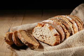 Sliced loaf of assorted rye bread on hessian
