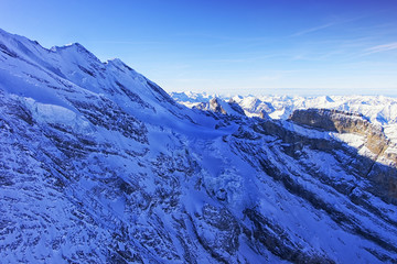 Peak and coomb in Jungfrau region helicopter view in winter