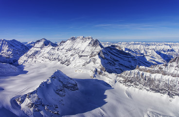 Mountain peaks chain in Jungfrau region helicopter view in winte