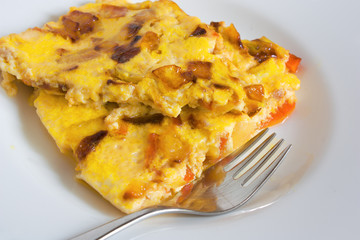 scrambled eggs with carrots and onions on a white plate