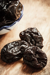 dried plums prunes on wooden table