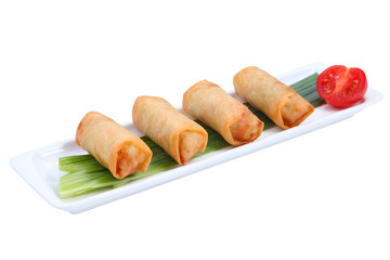 Four Chinese spring rolls on a white long, narrow plate.