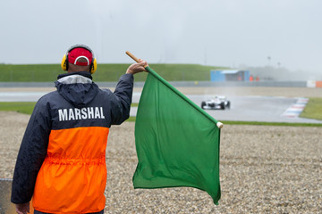 Marshal waving a green flag - 71918912