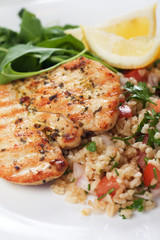 Chicken meat with bulgur and rocket salad