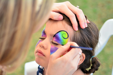 Fototapeta premium Little girl getting her face painted