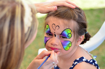 Fototapeta premium Little girl getting her face painted