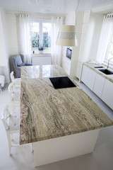 Big granitic worktop in bright kitchen