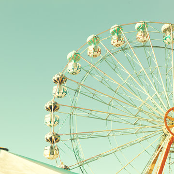 Vintage summer ferris wheel over mint sky