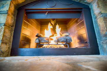 luxurious stone structure fireplace with burning fire