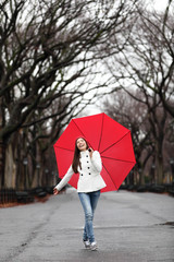 Woman with umbrella in fall in rain