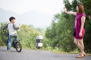 Fototapeta premium little Asian child with mother practice to riding a bicycle