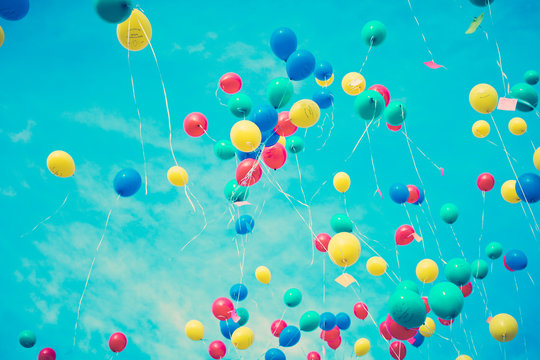 Vintage colorful helium balloons in blue sky