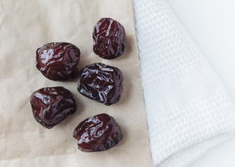 Dried prune on paper bag