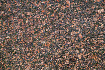 Dark red granite stone, closeup background texture