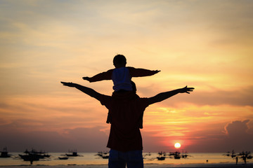 Fototapeta premium father and son having fun at sunset
