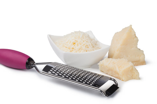 grated parmesan cheese and metal grater on white background