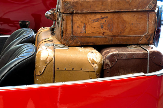 Old leather suitcases in  car trunk