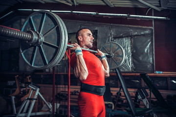 Powerlifter with strong arms lifting weights