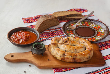 Ring homemade sausage on a cutting board