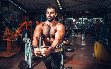Fototapeta na wymiar Body Builder Working Out At Gym
