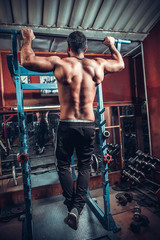 Fototapeta na wymiar Male Bodybuilder Doing Heavy Weight Exercise For Back