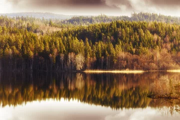 Fotobehang forest and hills mirrored in small inland lake © christian42