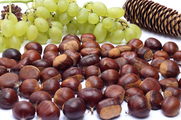 Chestnuts and grapes on white