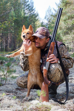 hunter embraces his dog