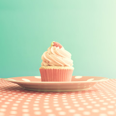 Strawberry cupcake over polka dots tablecloth