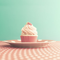 Strawberry cupcake over polka dots tablecloth