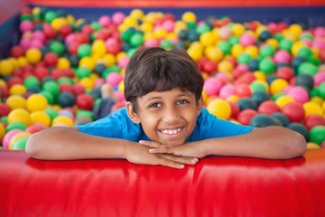 Cute boy smiling in ball pool