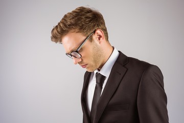 Young handsome businessman looking down