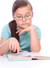 Cute girl is reading book