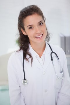 Happy brunette doctor with a stethoscope