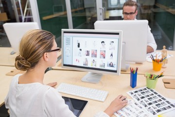 Photo editors using computers in office