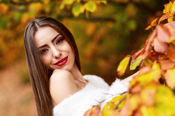 young brunette woman portrait in autumn color